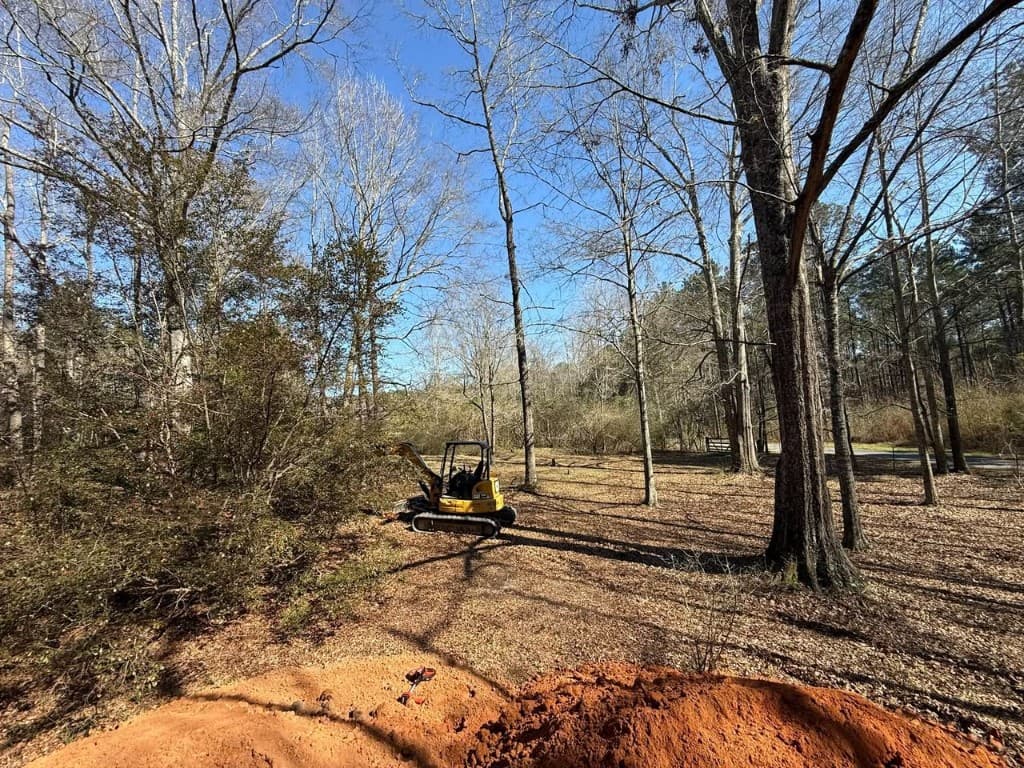 Mini excavator land clearing and excavation