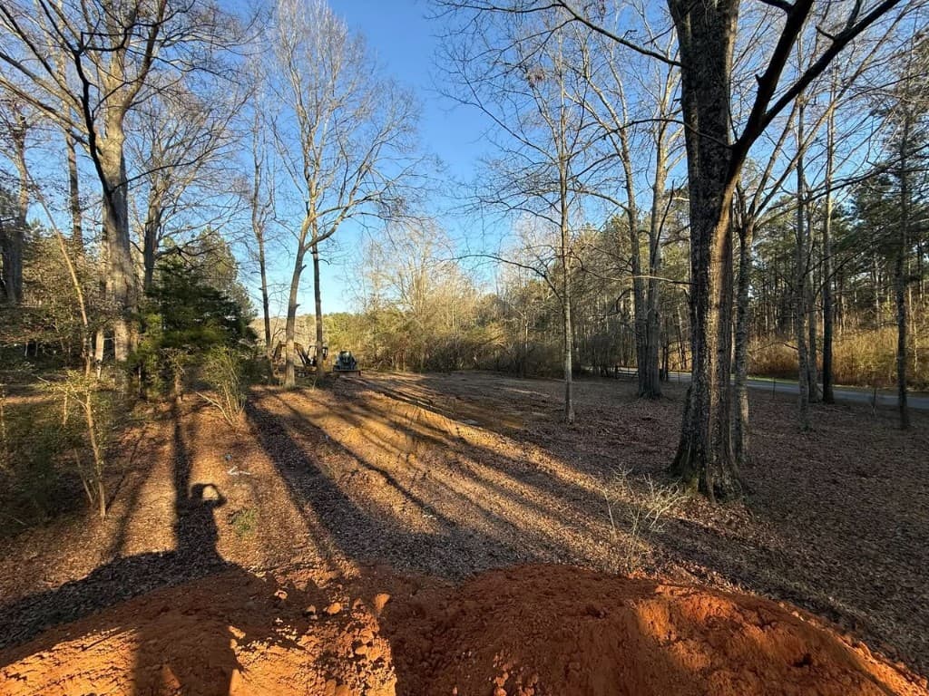 Land clearing site with excavator and equipment