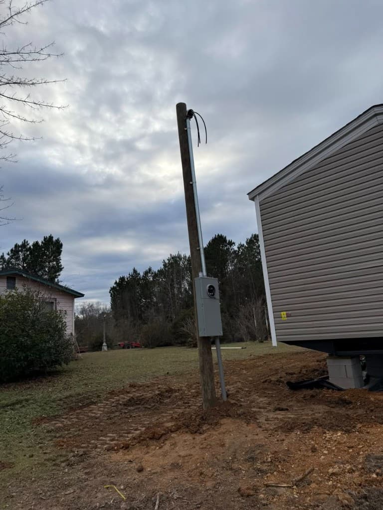 Meter pole installation and electrical service for modular home