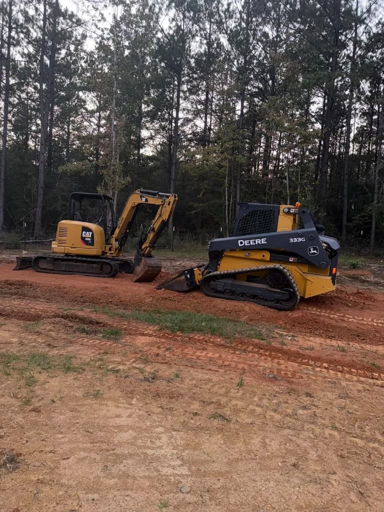 Excavation and track loader equipment on job site